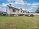Large backyard with a patio, lush lawn, and the house's rear, great for outdoor activities at 1209 Pressley Downs Se Dr, Concord, NC 28025
