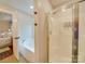 Bright bathroom features a soaking tub and a separate glass shower and access to main bedroom at 1209 Pressley Downs Se Dr, Concord, NC 28025