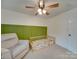 Cozy bedroom with chair, daybed, and soothing color scheme perfect for playtime and relaxation at 1209 Pressley Downs Se Dr, Concord, NC 28025