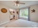 Comfortable bedroom showcases a window with backyard views and a closet with built-in storage at 1209 Pressley Downs Se Dr, Concord, NC 28025