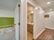Hallway view leading to a bedroom, featuring a half bathroom and modern flooring at 1209 Pressley Downs Se Dr, Concord, NC 28025