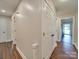 Bright hallway with hardwood floors, offering access to various rooms and closet space at 1209 Pressley Downs Se Dr, Concord, NC 28025