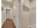 A hallway features wood floors and white walls, creating a bright and inviting space at 1209 Pressley Downs Se Dr, Concord, NC 28025