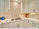 A well-equipped kitchen includes stainless steel appliances, light countertops, and brick backsplash at 1209 Pressley Downs Se Dr, Concord, NC 28025