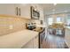 An open kitchen flows into the dining area, featuring stainless steel appliances and light countertops at 1209 Pressley Downs Se Dr, Concord, NC 28025