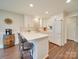 Bright kitchen featuring white cabinetry, stainless appliances, and breakfast bar with seating at 1209 Pressley Downs Se Dr, Concord, NC 28025