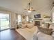 Bright living room featuring a fireplace, large windows, hardwood floors, and comfortable seating at 1209 Pressley Downs Se Dr, Concord, NC 28025