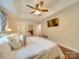 Spacious main bedroom with tray ceiling, fan, and TV; features hardwood floors and neutral walls at 1209 Pressley Downs Se Dr, Concord, NC 28025