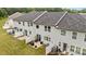 Aerial view of townhome exteriors showing patios and backyards at 12205 Gambrell Dr, Charlotte, NC 28278
