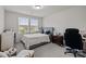 Comfortable bedroom with neutral tones, lots of natural light, and a well-organized workspace at 12205 Gambrell Dr, Charlotte, NC 28278