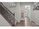 Hallway featuring a staircase, wood-look flooring, and a view of the front door at 12205 Gambrell Dr, Charlotte, NC 28278