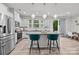 Open kitchen with an island, granite countertops, stainless steel appliances, and a view into the dining area at 12205 Gambrell Dr, Charlotte, NC 28278