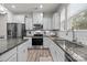 Well-equipped kitchen featuring white cabinetry, granite countertops, stainless steel appliances, and a subway tile backsplash at 12205 Gambrell Dr, Charlotte, NC 28278