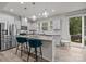 Bright kitchen featuring granite counters, stainless appliances, island with bar seating and access to the backyard at 12205 Gambrell Dr, Charlotte, NC 28278