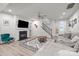 Spacious living room featuring a fireplace, staircase, and modern decor at 12205 Gambrell Dr, Charlotte, NC 28278