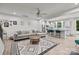 Open-concept living room with a modern decor, eat-in kitchen, and light-colored flooring at 12205 Gambrell Dr, Charlotte, NC 28278