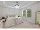 Calming main bedroom featuring neutral tones, tray ceiling, large windows, and cozy furnishings at 12205 Gambrell Dr, Charlotte, NC 28278