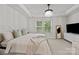 Bright main bedroom showcasing a tray ceiling, large windows, and neutral decor at 12205 Gambrell Dr, Charlotte, NC 28278