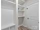 Mudroom featuring built-in shelving, a bench, and access to a closet at 12205 Gambrell Dr, Charlotte, NC 28278