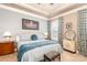 Comfortable bedroom featuring stylish décor, a tray ceiling, and soft natural light from the window at 128 Asher Ln, Mooresville, NC 28115