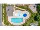 Aerial view of a pristine community pool with ample seating and adjacent playground at 128 Asher Ln, Mooresville, NC 28115