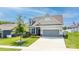 Beautiful home featuring a well-maintained lawn, attractive landscaping, and a gray two-car garage at 128 Asher Ln, Mooresville, NC 28115