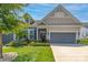Charming front exterior of home featuring manicured lawn, tasteful landscaping, and a welcoming facade at 128 Asher Ln, Mooresville, NC 28115