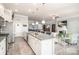 Open-concept kitchen with granite island and stainless appliances, flowing into a bright living area at 128 Asher Ln, Mooresville, NC 28115