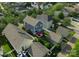 Birds-eye view of home with a red umbrella in backyard, fence, garage, and surrounding lush greenery at 14034 Holly Springs Dr, Huntersville, NC 28078