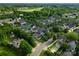 Wide aerial shot showcases neighborhood, mature trees, and homes near green space at 14034 Holly Springs Dr, Huntersville, NC 28078