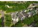 High angle view of the home, set amongst dense tree coverage and other residential properties at 14034 Holly Springs Dr, Huntersville, NC 28078