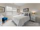 Cozy bedroom with white iron bed frame, soft carpet, and natural light from the window at 14034 Holly Springs Dr, Huntersville, NC 28078