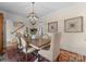 Charming dining room boasts a farmhouse table, unique lighting, and an inviting atmosphere at 14034 Holly Springs Dr, Huntersville, NC 28078