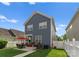 Backyard view of a blue siding home featuring a concrete patio with grill and lawn at 14034 Holly Springs Dr, Huntersville, NC 28078