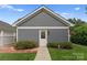 Well-maintained detached garage with stylish gray siding and manicured landscaping at 14034 Holly Springs Dr, Huntersville, NC 28078