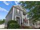 Charming two-story home with a welcoming porch and an American flag displayed at 14034 Holly Springs Dr, Huntersville, NC 28078