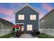 Two-story home with blue siding, white trim, and outdoor patio set, great for entertaining at 14034 Holly Springs Dr, Huntersville, NC 28078
