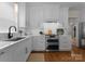 Modern kitchen with stainless steel appliances, white cabinets, and ample counter space at 14034 Holly Springs Dr, Huntersville, NC 28078