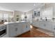 Bright, open kitchen with white cabinetry, large island, and easy access to living areas at 14034 Holly Springs Dr, Huntersville, NC 28078