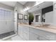 The main bathroom features marble countertops, double sinks, and a tiled walk-in shower, perfect for relaxation at 14034 Holly Springs Dr, Huntersville, NC 28078