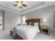 Inviting main bedroom with plush carpet, tray ceiling, a ceiling fan, and ample natural light at 14034 Holly Springs Dr, Huntersville, NC 28078