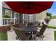 Back patio including a wicker table and chairs, along with a stainless steel grill at 14034 Holly Springs Dr, Huntersville, NC 28078