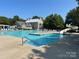 Community pool features a slide and ample seating, perfect for summer fun at 14034 Holly Springs Dr, Huntersville, NC 28078