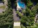 Aerial view of the community pool, parking, pool house and basketball court, surrounded by trees at 1408 Rinehart Ct, Charlotte, NC 28270