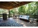 Spacious back deck with grill, dining set, and comfortable seating with forest view at 1408 Rinehart Ct, Charlotte, NC 28270