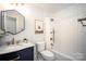 Stylish bathroom featuring a marble sink, blue vanity, and a shower with subway tile at 1408 Rinehart Ct, Charlotte, NC 28270