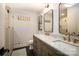 Bathroom with a double vanity, wood cabinets, and a glass-enclosed shower at 1408 Rinehart Ct, Charlotte, NC 28270