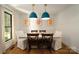 Elegant dining area featuring modern lighting, hardwood floors, and a large window at 1408 Rinehart Ct, Charlotte, NC 28270