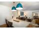 Bright dining area with stylish lighting, hardwood floors, and a view into the living room at 1408 Rinehart Ct, Charlotte, NC 28270