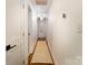 Bright hallway features hardwood floors, white walls, and access to other rooms at 1408 Rinehart Ct, Charlotte, NC 28270